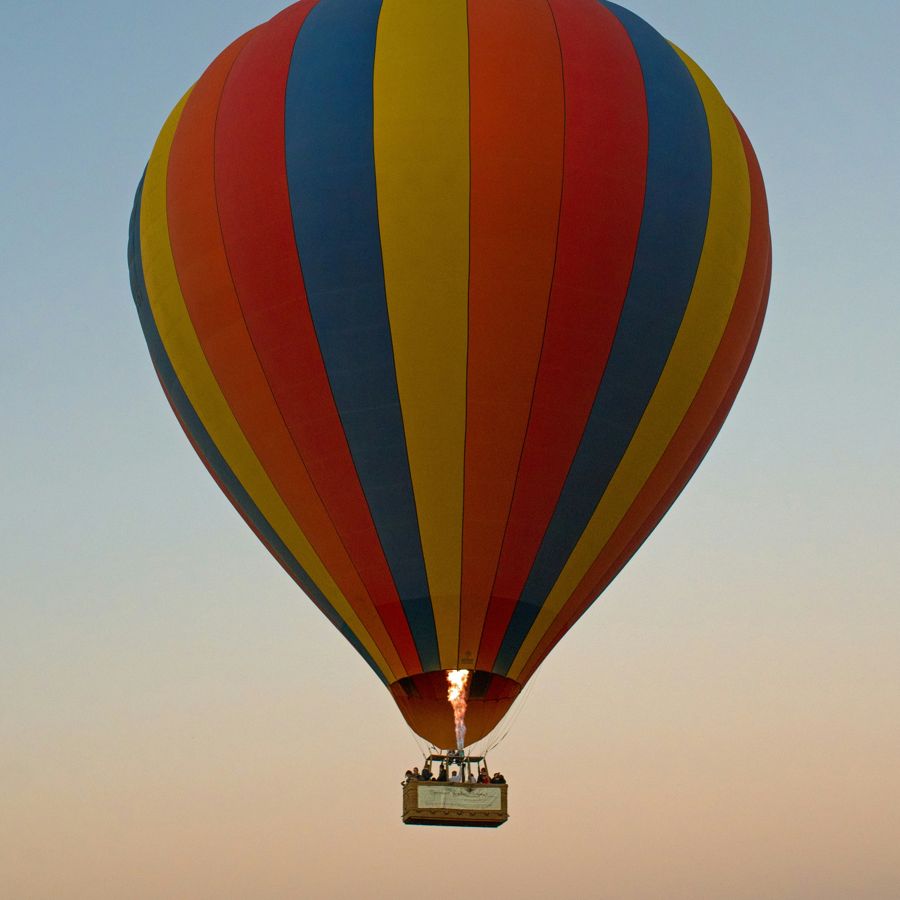 Hot air balloon safari drifting over the Mara at dawn